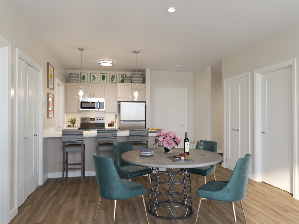 Photo of a mid-sized modern kitchen/dining combo in Tampa with beige walls and laminate floors.