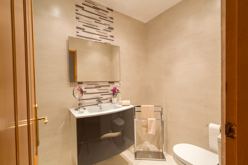 Inspiration for a mid-sized contemporary 3/4 wet room bathroom in Other with furniture-like cabinets, grey cabinets, a one-piece toilet, beige tile, porcelain tile, beige walls, porcelain floors, a drop-in sink and marble benchtops.