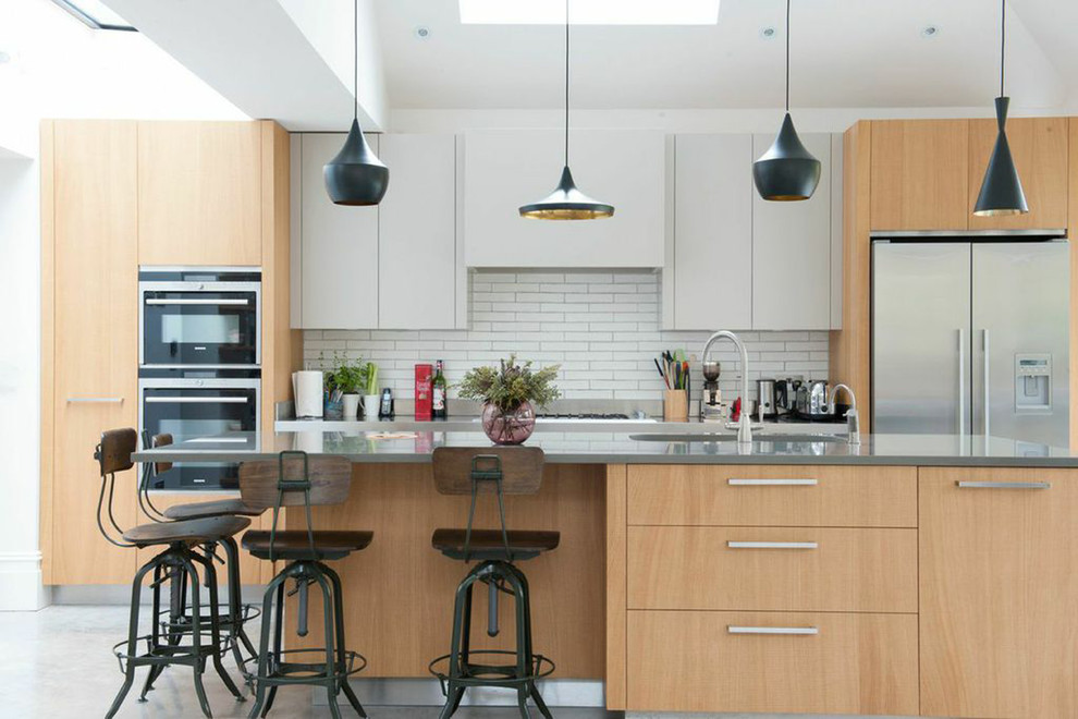 This is an example of a contemporary kitchen in London with with island.