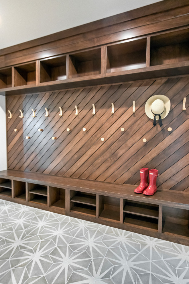 Inspiration for a transitional porcelain tile, gray floor and wood wall entry hall remodel