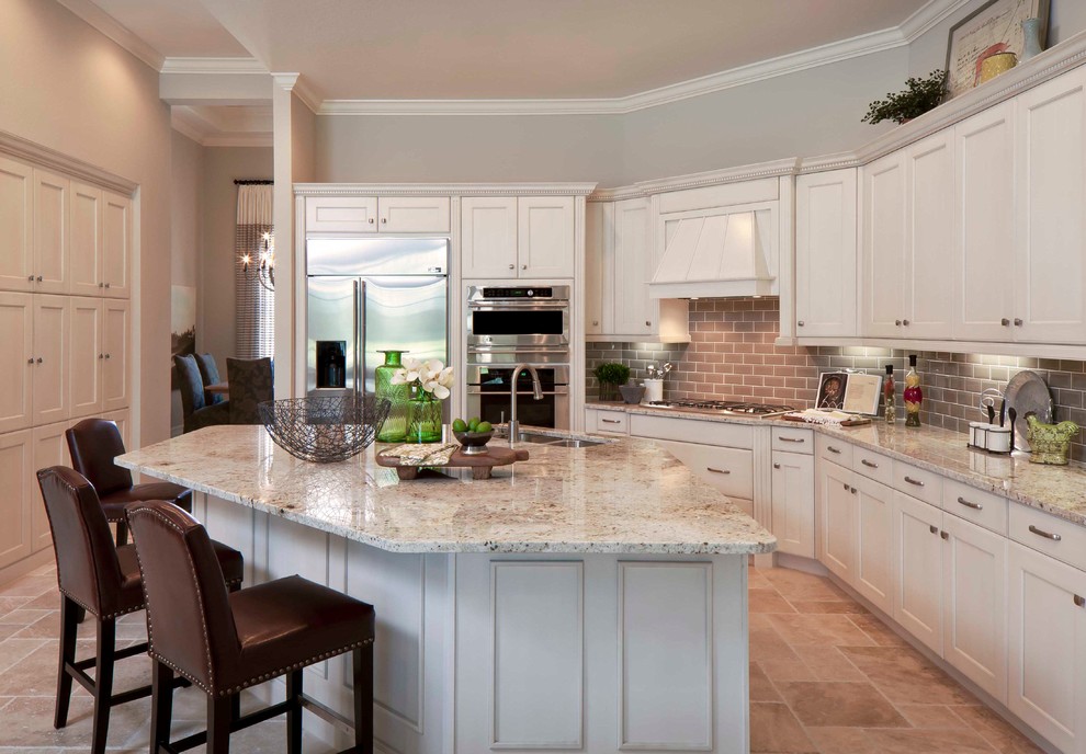 Kitchen - large transitional kitchen idea in Miami with a double-bowl sink, recessed-panel cabinets, white cabinets, white appliances, beige walls and an island