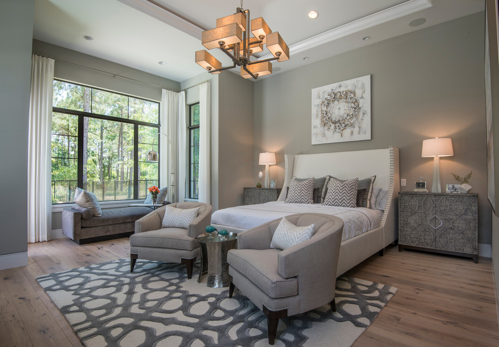 Inspiration for a large transitional master bedroom in Orlando with grey walls, medium hardwood floors and brown floor.