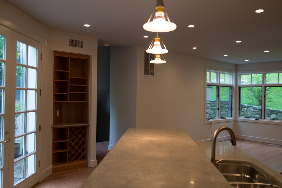 Large transitional l-shaped medium tone wood floor eat-in kitchen photo with a double-bowl sink, recessed-panel cabinets, medium tone wood cabinets, concrete countertops, multicolored backsplash, matchstick tile backsplash, stainless steel appliances and an island