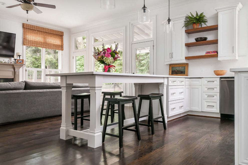 Large arts and crafts u-shaped eat-in kitchen in Atlanta with an undermount sink, recessed-panel cabinets, white cabinets, quartz benchtops, white splashback, stone slab splashback, stainless steel appliances, dark hardwood floors, a peninsula, brown floor and white benchtop.