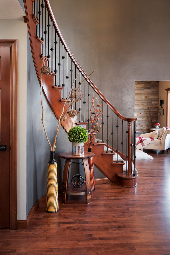 Photo of a mid-sized traditional wood curved staircase in Milwaukee with wood risers and mixed railing.