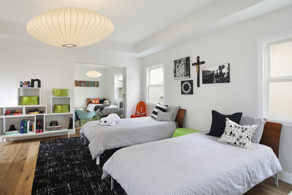Inspiration for a large contemporary gender-neutral kids' bedroom in Orange County with white walls, medium hardwood floors and brown floor.