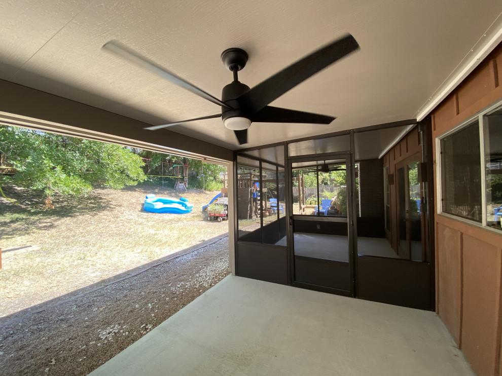 Design ideas for a modern back patio in Austin with concrete slabs and an awning.