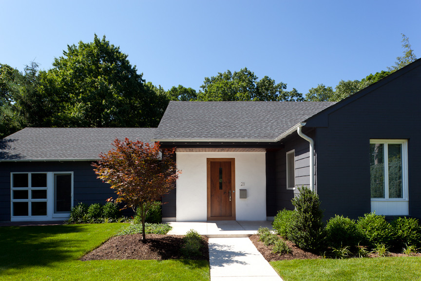 Photo of a large contemporary two-storey grey exterior in Philadelphia with wood siding.