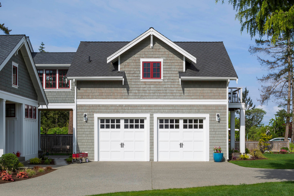 This is an example of a large beach style two-storey grey house exterior in Seattle with wood siding, a gable roof and a shingle roof.