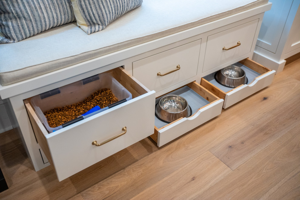 Large transitional u-shaped light wood floor kitchen photo with an undermount sink, shaker cabinets, white cabinets, quartz countertops, white backsplash, marble backsplash, paneled appliances, two islands and white countertops