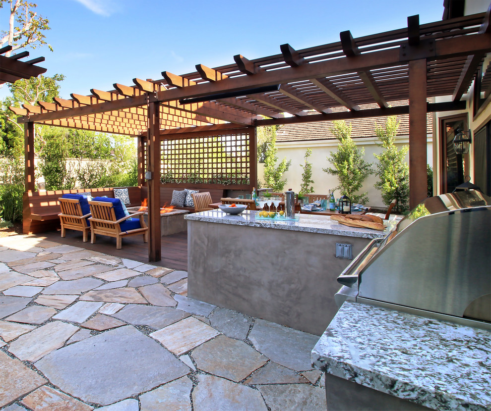 Inspiration for a mid-sized contemporary backyard patio in Los Angeles with a fire feature and natural stone pavers.