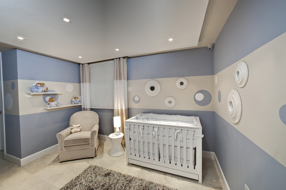 Photo of a mid-sized modern nursery for boys in Other with blue walls.