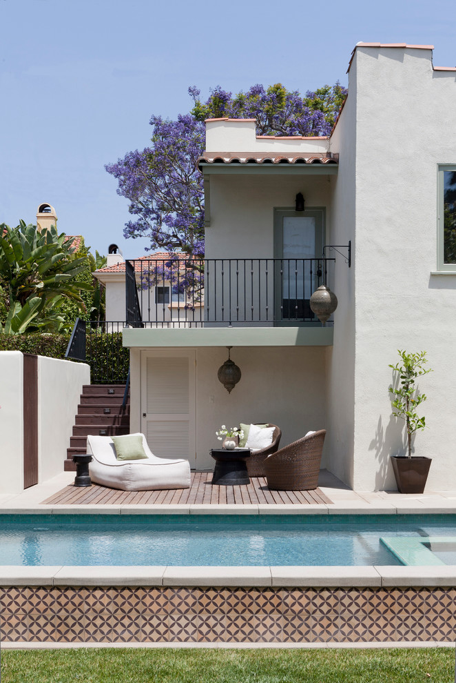 Mediterranean rectangular lap pool in Los Angeles with decking.