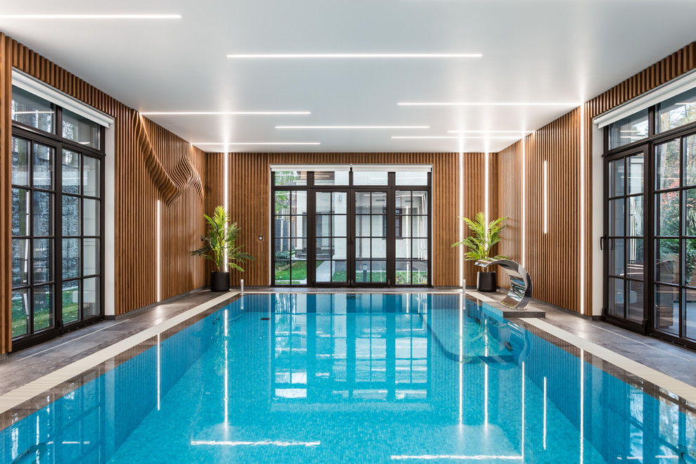 This is an example of a large contemporary indoor rectangular lap pool in Moscow with a water feature and tile.