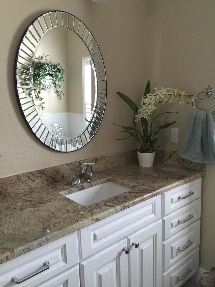 Medium sized contemporary ensuite bathroom in Orlando with white cabinets, a freestanding bath, beige walls, ceramic flooring, a submerged sink and raised-panel cabinets.