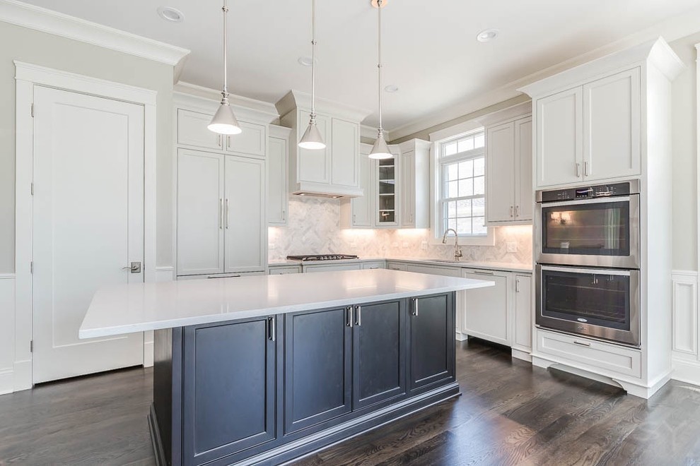 Eat-in kitchen - mid-sized transitional l-shaped dark wood floor eat-in kitchen idea in Chicago with shaker cabinets, white cabinets, gray backsplash, stone tile backsplash, stainless steel appliances and an island