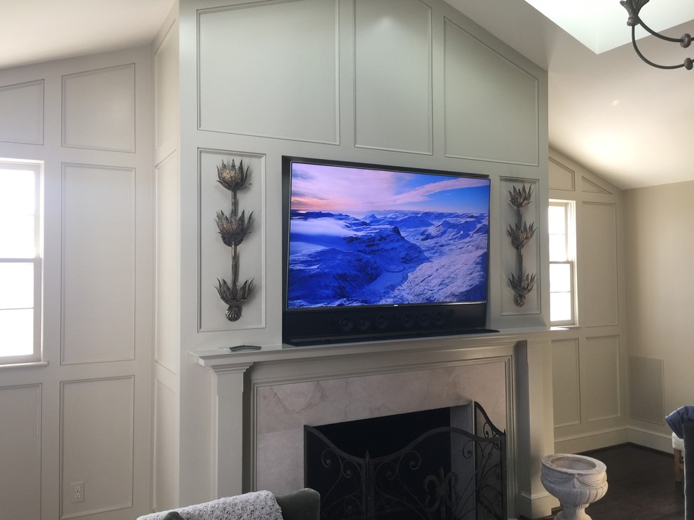 Design ideas for a large transitional enclosed family room in DC Metro with white walls, a standard fireplace, a stone fireplace surround and a wall-mounted tv.