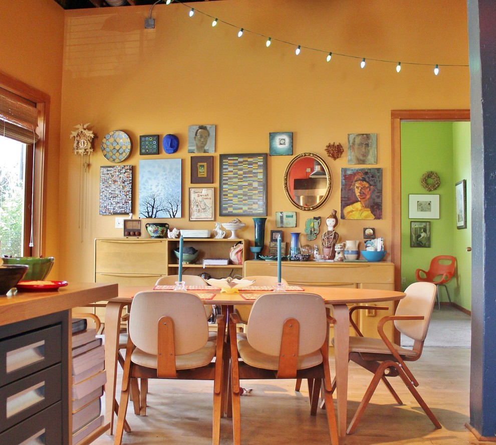 Example of an eclectic kitchen/dining room combo design in Seattle with yellow walls and no fireplace