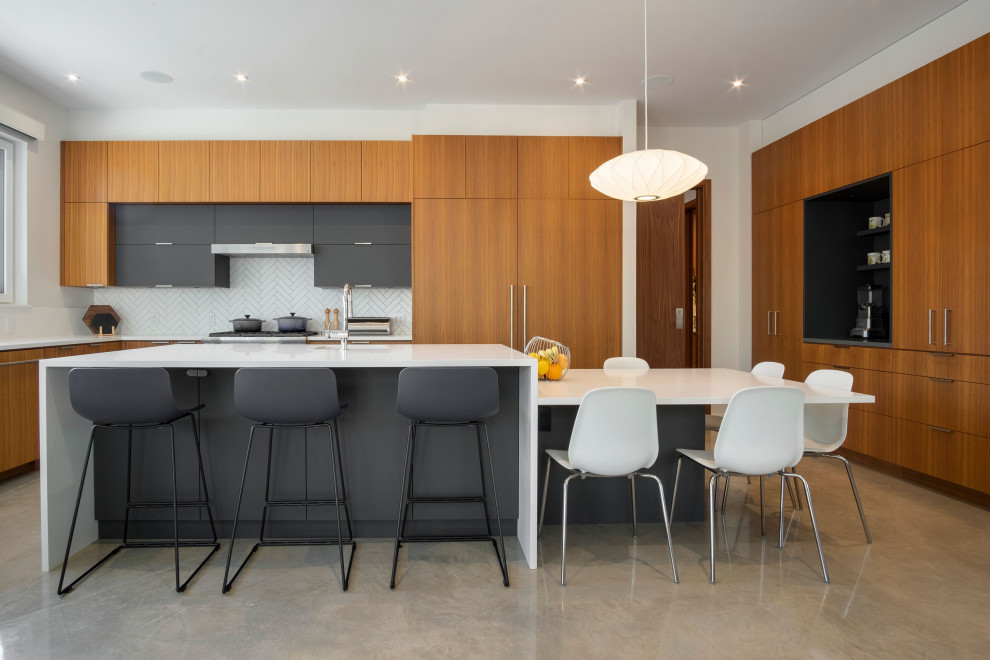 Design ideas for a modern l-shaped eat-in kitchen in Vancouver with an undermount sink, flat-panel cabinets, medium wood cabinets, quartz benchtops, white splashback, ceramic splashback, panelled appliances, concrete floors, with island, grey floor and white benchtop.