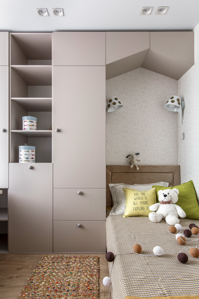 This is an example of a mid-sized contemporary kids' bedroom for girls in Other with brown floor.