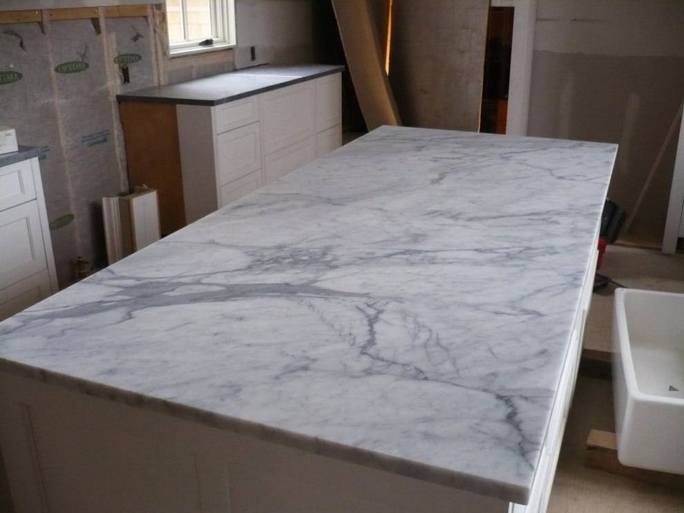 This is an example of a rural kitchen in London with marble worktops and white worktops.