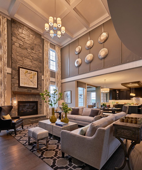 This is an example of a large transitional open concept family room in Philadelphia with grey walls, dark hardwood floors, a standard fireplace and a stone fireplace surround.