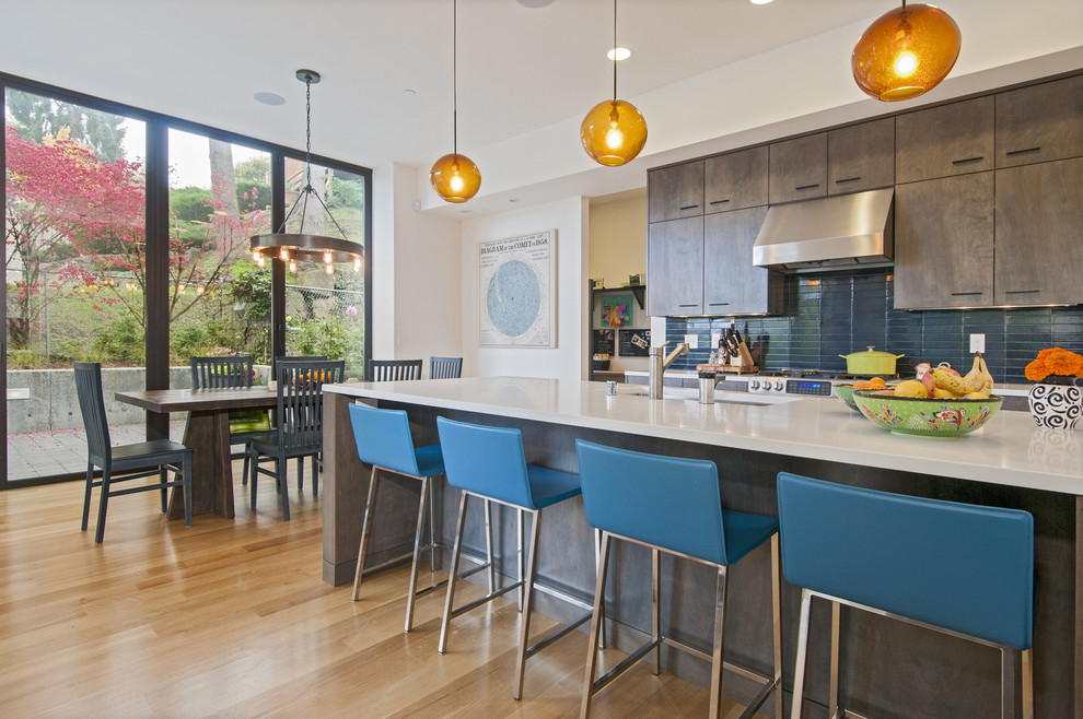 Inspiration for a contemporary eat-in kitchen in Seattle with an undermount sink, flat-panel cabinets, dark wood cabinets and blue splashback.