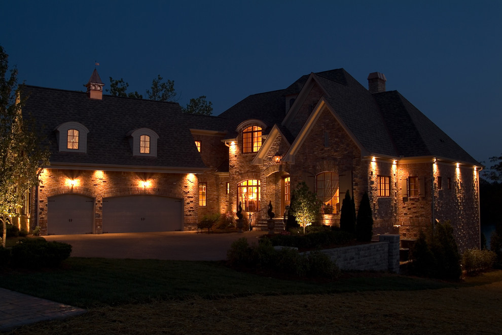 Mid-sized traditional two-storey beige exterior in Nashville with stone veneer and a gable roof.