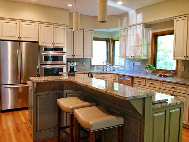 Open concept kitchen - large transitional l-shaped light wood floor open concept kitchen idea in Columbus with a drop-in sink, raised-panel cabinets, white cabinets, green backsplash, stainless steel appliances and an island
