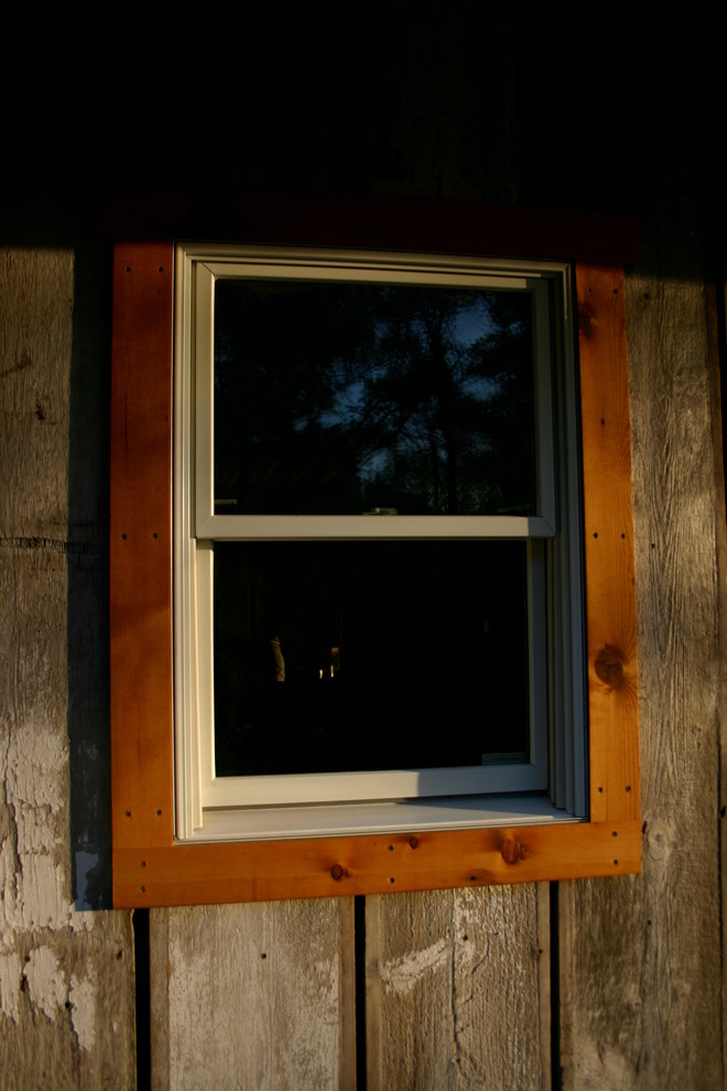 Example of a large mountain style brown two-story wood gable roof design