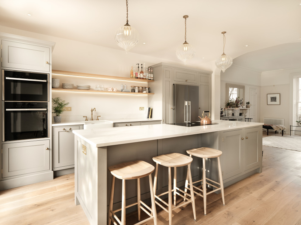 Design ideas for a medium sized classic kitchen in Other with shaker cabinets, beige cabinets, an island and white worktops.