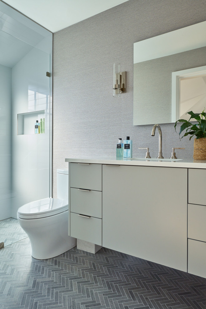 Photo of a modern bathroom in New York with flat-panel cabinets, white cabinets, a freestanding tub, a curbless shower, grey walls, porcelain floors, an undermount sink, recycled glass benchtops, grey floor, a hinged shower door, white benchtops, a floating vanity and a single vanity.