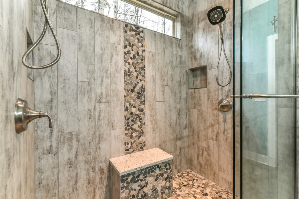This is an example of a mid-sized arts and crafts master bathroom in Other with shaker cabinets, dark wood cabinets, an alcove shower, multi-coloured tile, pebble tile, blue walls, an undermount sink, limestone benchtops, brown floor, a sliding shower screen, white benchtops, a two-piece toilet and vinyl floors.