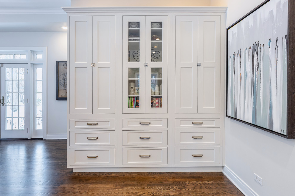 Inspiration for a large transitional u-shaped dark wood floor and brown floor eat-in kitchen remodel in Chicago with a farmhouse sink, beaded inset cabinets, white cabinets, quartz countertops, gray backsplash, glass tile backsplash, stainless steel appliances, an island and white countertops