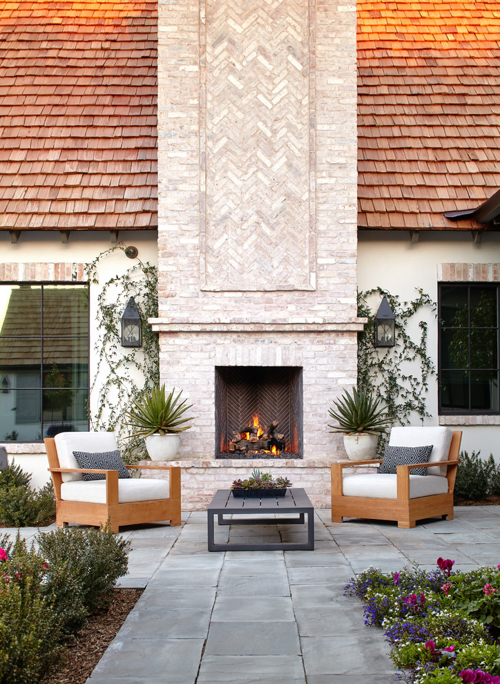 Inspiration for a transitional backyard patio in Phoenix with with fireplace.