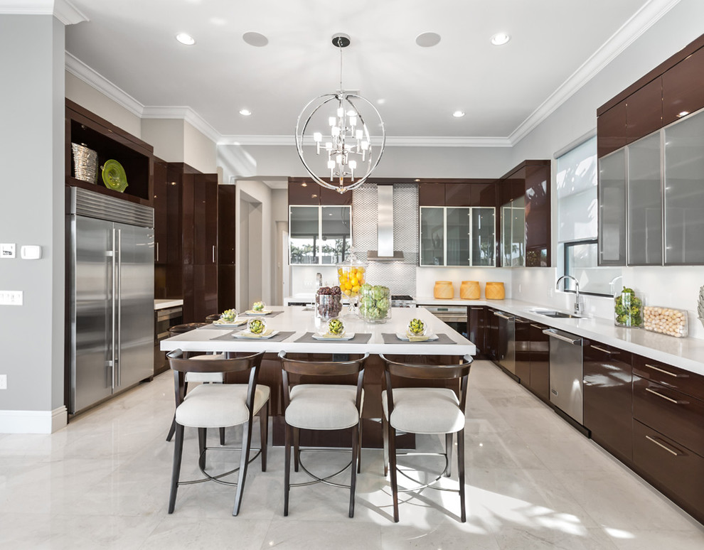 Inspiration for a large transitional u-shaped marble floor eat-in kitchen remodel in Orange County with an undermount sink, flat-panel cabinets, brown cabinets, quartz countertops, stainless steel appliances, an island, white backsplash and glass sheet backsplash