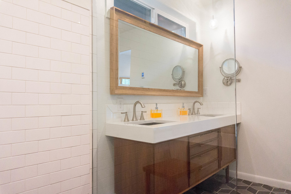 Inspiration for a mid-sized midcentury master bathroom in Boise with a freestanding tub, a curbless shower, a one-piece toilet, white tile, pebble tile, white walls, porcelain floors, an undermount sink, beaded inset cabinets, medium wood cabinets, quartzite benchtops and a hinged shower door.