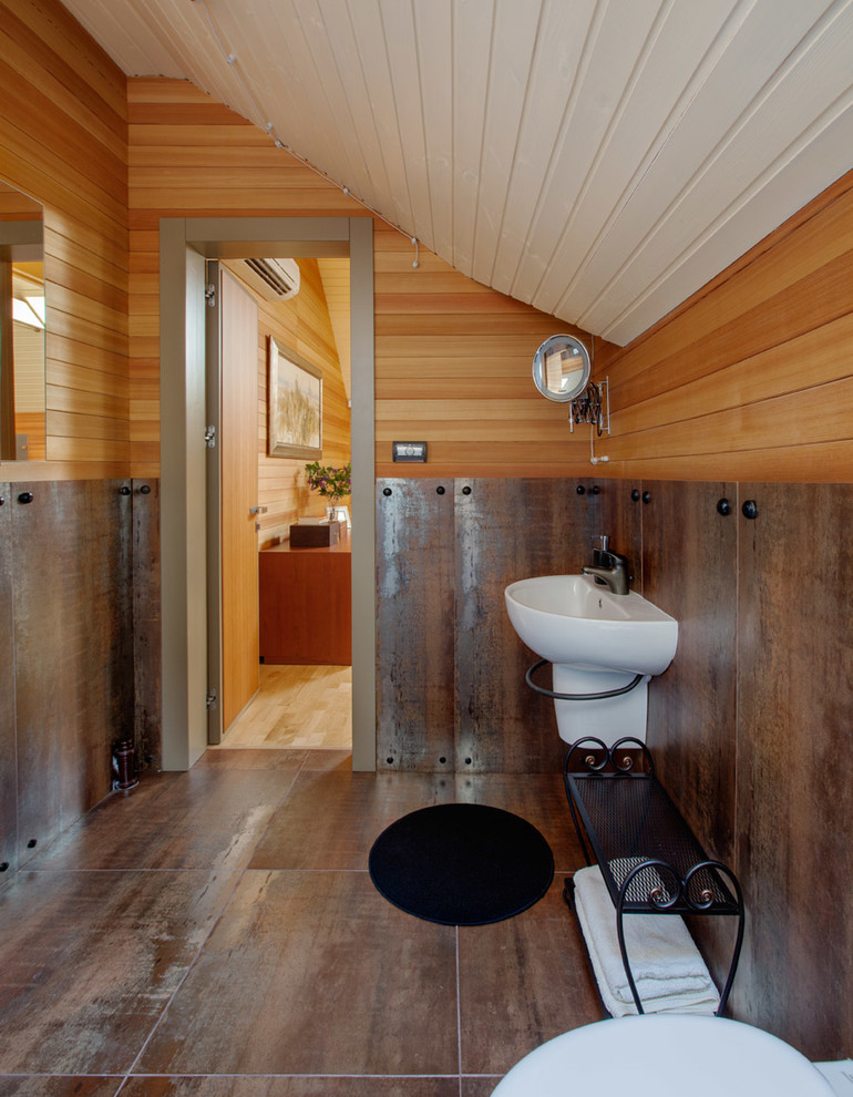 Photo of a mid-sized contemporary 3/4 bathroom in Moscow with a wall-mount toilet, brown tile, metal tile, porcelain floors, a wall-mount sink and brown walls.