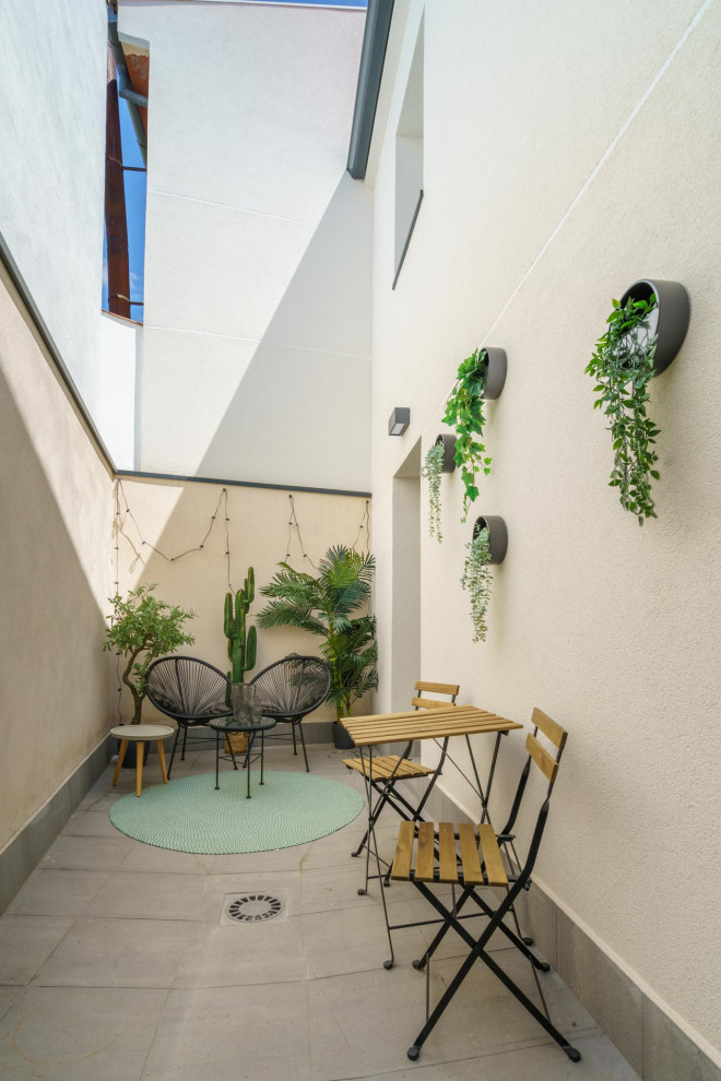 Design ideas for a small world-inspired back ground level terrace in Other with a living wall and no cover.