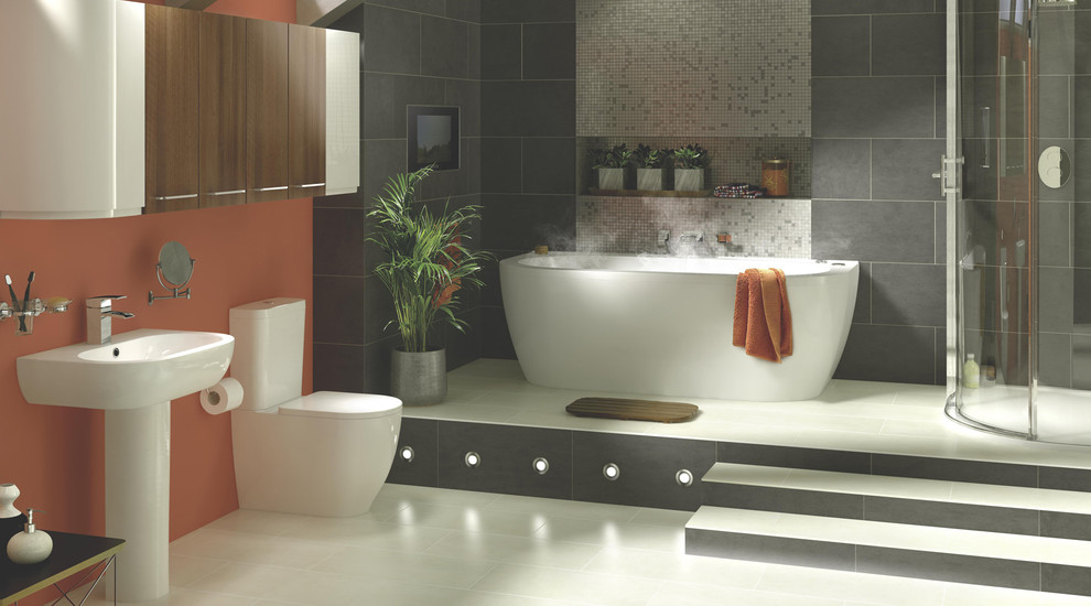 Design ideas for a large contemporary master bathroom in Hampshire with a wall-mount sink, flat-panel cabinets, dark wood cabinets, a freestanding tub, gray tile, orange walls, porcelain floors, a corner shower and a one-piece toilet.