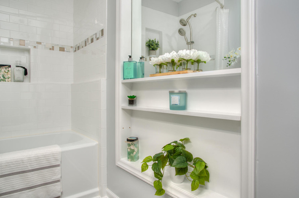 Design ideas for a beach style bathroom in Other with beaded inset cabinets, grey cabinets, an alcove tub, a shower/bathtub combo, a two-piece toilet, white tile, subway tile, white walls, an undermount sink, brown floor and a shower curtain.