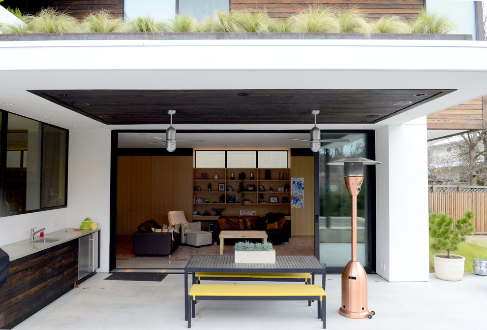This is an example of a contemporary patio in Austin with an outdoor kitchen.