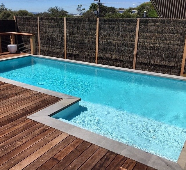 Inspiration for a small modern backyard rectangular lap pool in Melbourne with natural stone pavers.