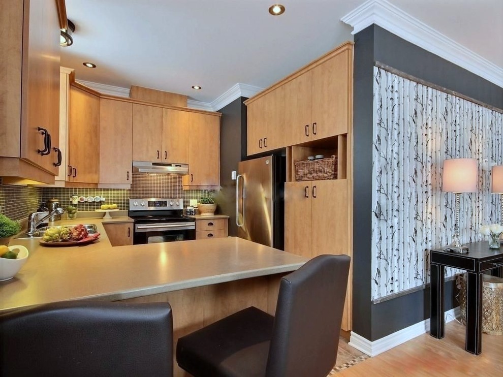 Inspiration for a transitional u-shaped kitchen pantry remodel in Montreal with a double-bowl sink, flat-panel cabinets, medium tone wood cabinets, laminate countertops, black backsplash, ceramic backsplash and stainless steel appliances