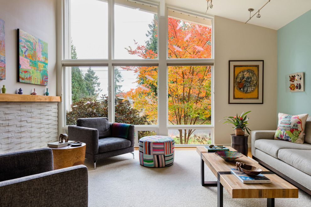Design ideas for a mid-sized midcentury open concept living room in Seattle with multi-coloured walls, light hardwood floors, a standard fireplace, a stone fireplace surround and no tv.
