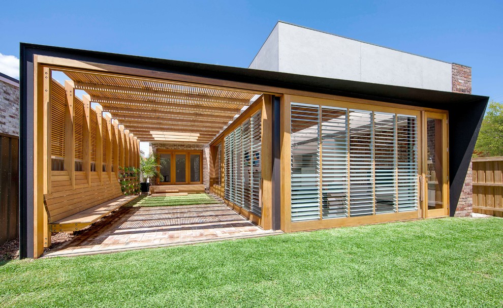 Photo of a modern backyard full sun garden in Sydney with brick pavers.