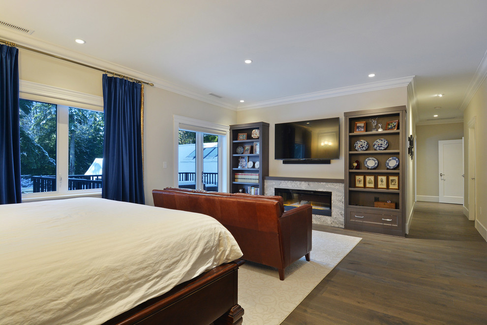 Photo of a large traditional master bedroom in Vancouver with beige walls, medium hardwood floors, a standard fireplace, a tile fireplace surround and brown floor.