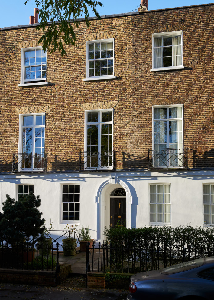 Photo of a large traditional brick townhouse exterior in London with four or more storeys.