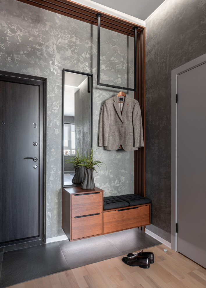 Inspiration for a medium sized contemporary hallway in Saint Petersburg with grey walls, porcelain flooring, a single front door, a grey front door and grey floors.