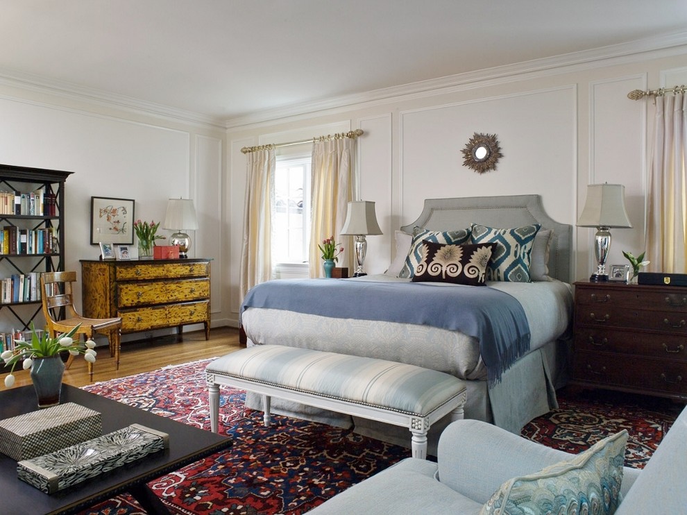 This is an example of a large mediterranean master bedroom in San Francisco with white walls and medium hardwood floors.